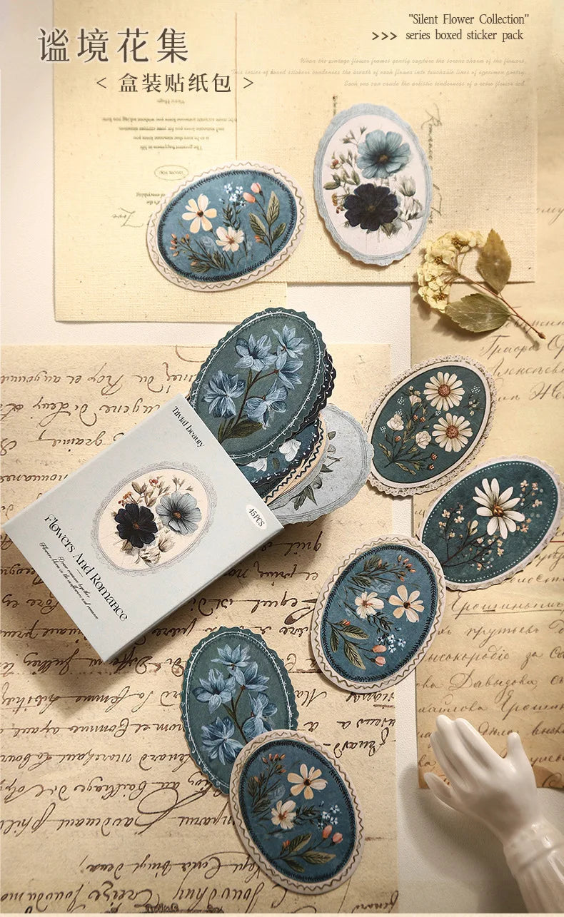 A collection of vintage floral stickers featuring blue, white, and gray flowers on kraft paper.