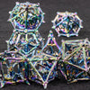 A set of intricate, iridescent metal dice shaped like blood dragons for tabletop role-playing games