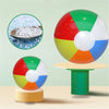A set of six colorful rainbow inflatable beach balls, including a large ball and smaller ones, displayed on a stand.
