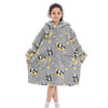 A young girl models a gray flannel hoodie sweater decorated with black and yellow panda patterns and gold stars.