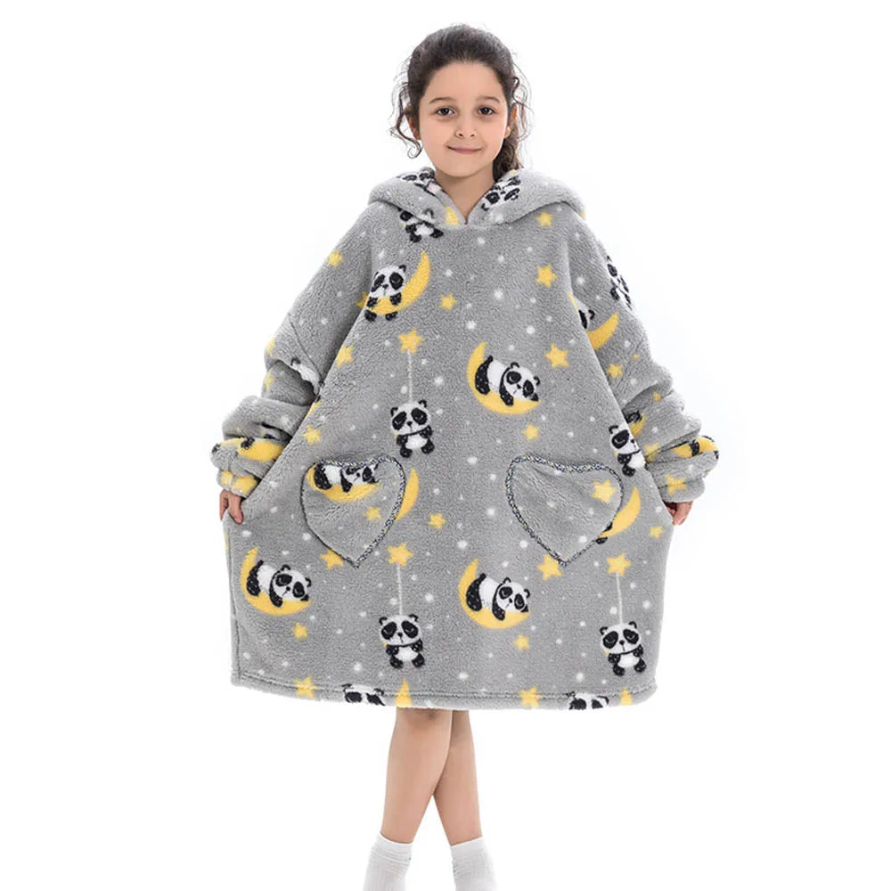 A young girl models a gray flannel hoodie sweater decorated with black and yellow panda patterns and gold stars.