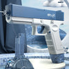 A blue electric automatic water gun is shown next to a clear drum magazine and some small targets on a surface.