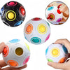 A collection of colorful foam cubes and a hand demonstrating the matching colored rings for a fidget toy.