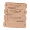 A stack of four light brown leather-style handmade with love tags for crafts and sewing.