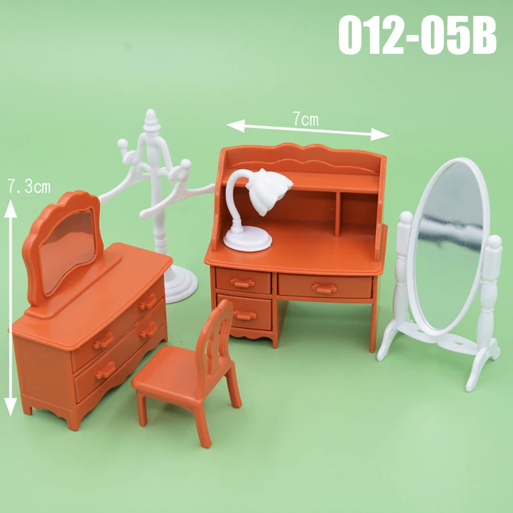 An orange dollhouse furniture playset featuring a dresser, chair, mirror, and a cabinet with a lamp.