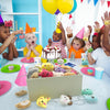 A collection of assorted mini animal plush toys and keychain loop toys laid out on a white table.