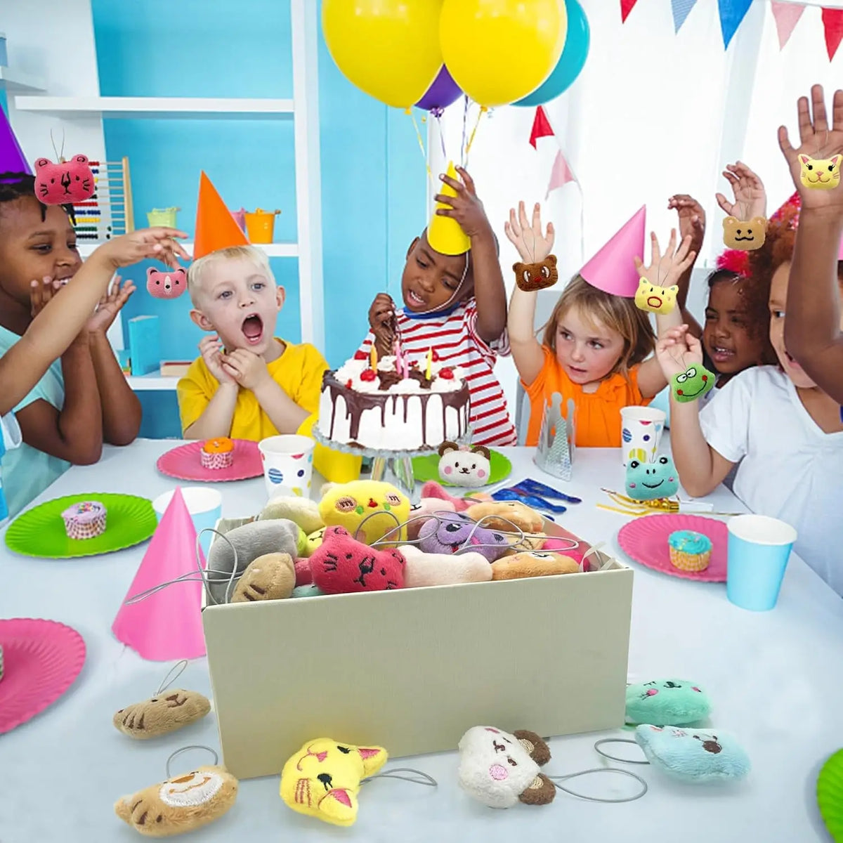 A collection of assorted mini animal plush toys and keychain loop toys laid out on a white table.