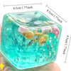 A clear blue ocean-themed squishy block filled with sea creatures and bubbles.