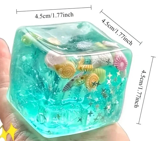 A clear blue ocean-themed squishy block filled with sea creatures and bubbles.