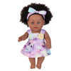 A 12-inch realistic African American baby doll with dark curly hair wearing a purple and white floral dress.