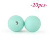 Two light mint green silicone beads, one with a hole, are shown against a white background.