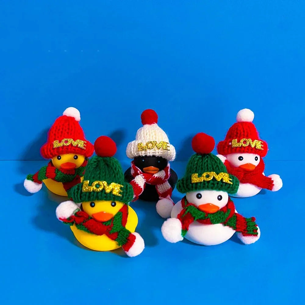 A set of mini rubber duck accessories including hats and sunglasses displayed against a blue background.