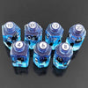 A set of seven floral resin potion bottle polyhedral dice numbered 4, 6, 8, 10, 12, 100, and 20.