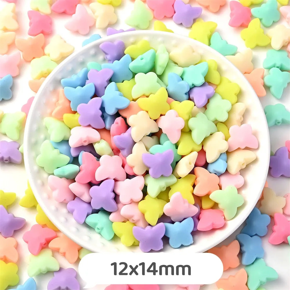 A bowl filled with pastel bear-shaped acrylic craft beads in various shades of pink, yellow, green, and blue.