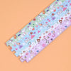 A collection of 27 assorted colored origami star strips for DIY crafting and decor, laid out diagonally.