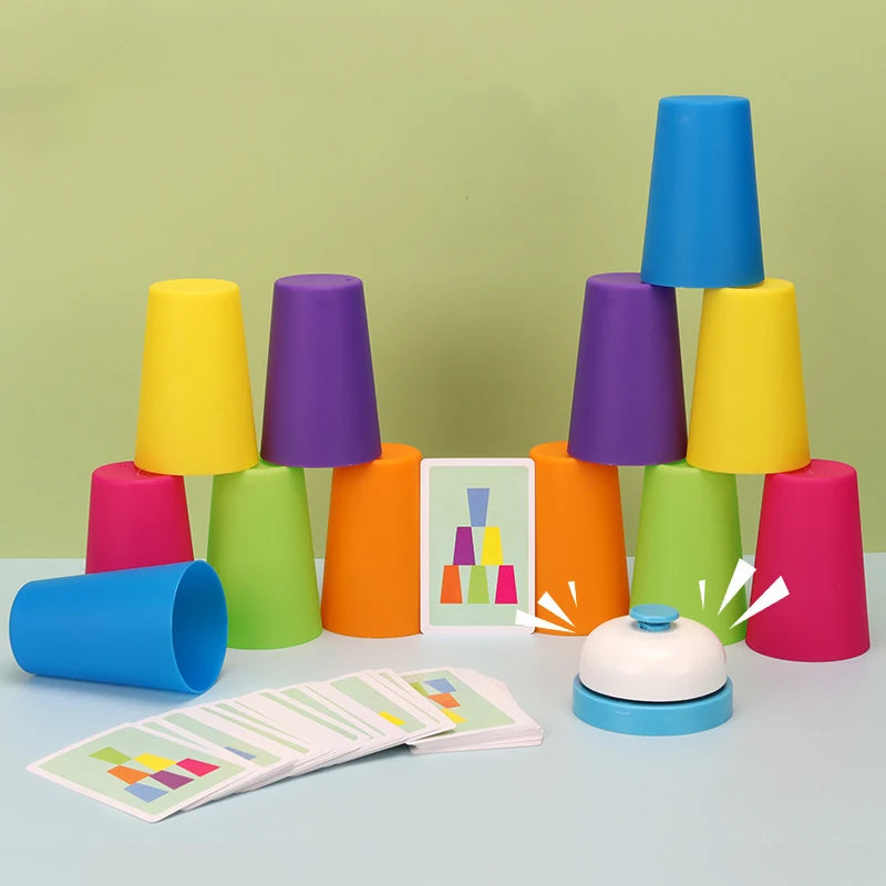 A colorful stacking cups game with a bell, featuring various shades of yellow, purple, green, and orange.