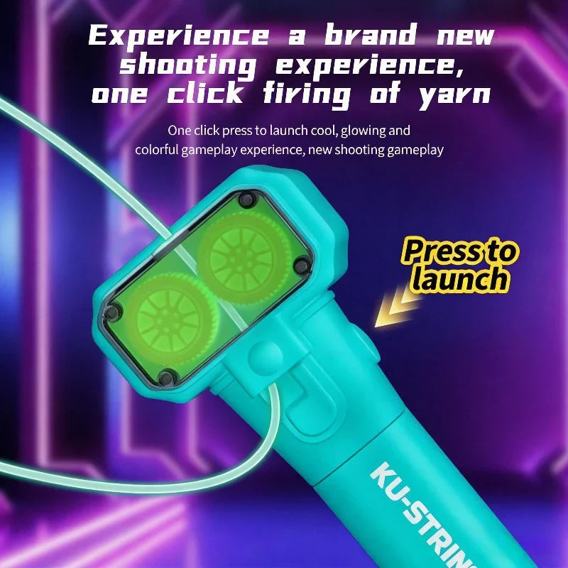 A close-up of a turquoise string launcher with a glowing green firing mechanism and a purple neon background.