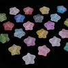 A collection of colorful transparent star acrylic beads in various shades of pink, purple, blue, and yellow.