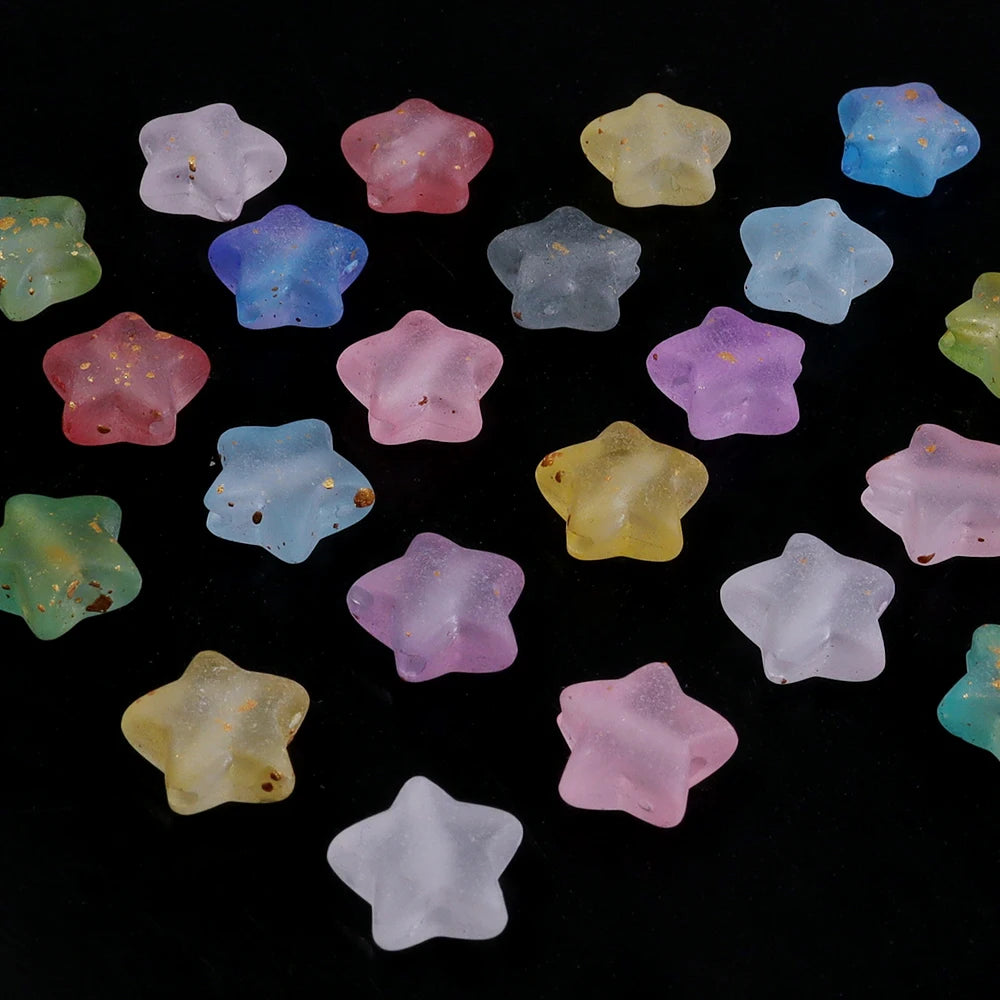 A collection of colorful transparent star acrylic beads in various shades of pink, purple, blue, and yellow.