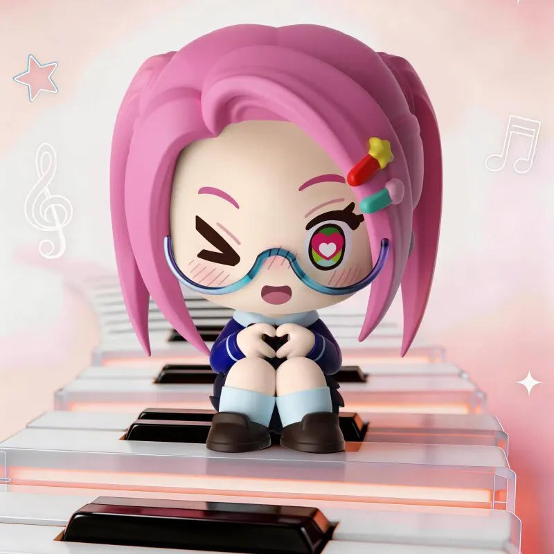 A blind box figure of a girl with pink hair and blue glasses sitting on a piano keyboard.