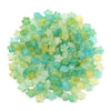 A pile of colorful transparent star acrylic beads in shades of green and blue.