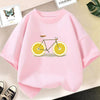 Pink graphic t-shirt featuring a bicycle decorated with sliced lemons and an avocado illustration