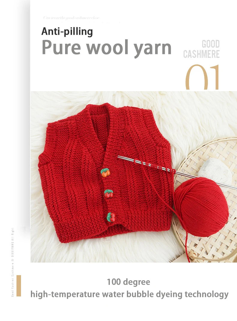 A bright red knitted sweater made from pure wool yarn displayed next to a ball of the same yarn.