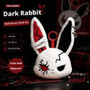A white rabbit plush toy with red bandage markings and black details, displayed on a dark surface.
