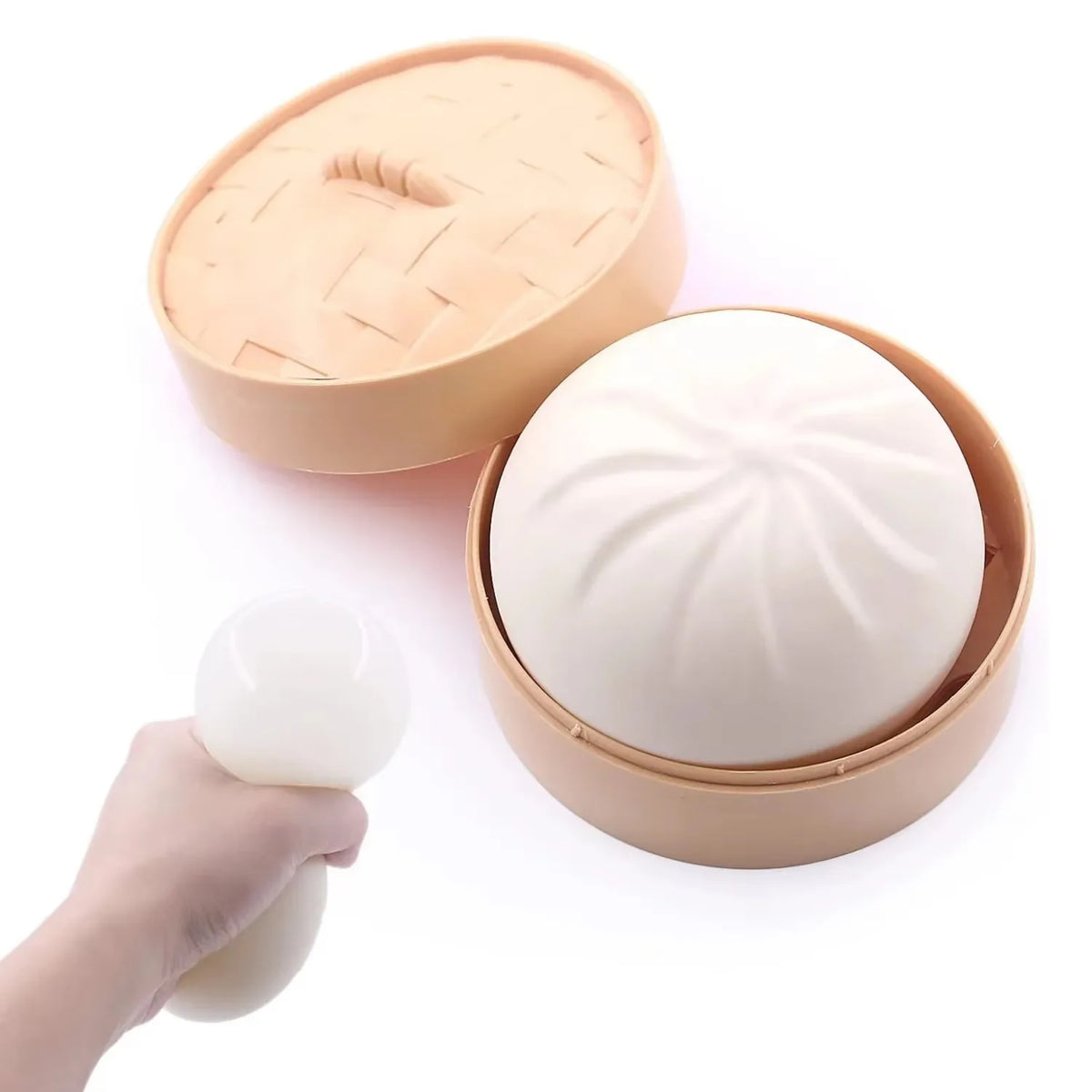 A light beige dumpling squishy stress ball is shown being removed from its round, fluted container.