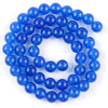 A string of round, polished blue beads made from natural sea sediment jasper and turquoise for jewelry making