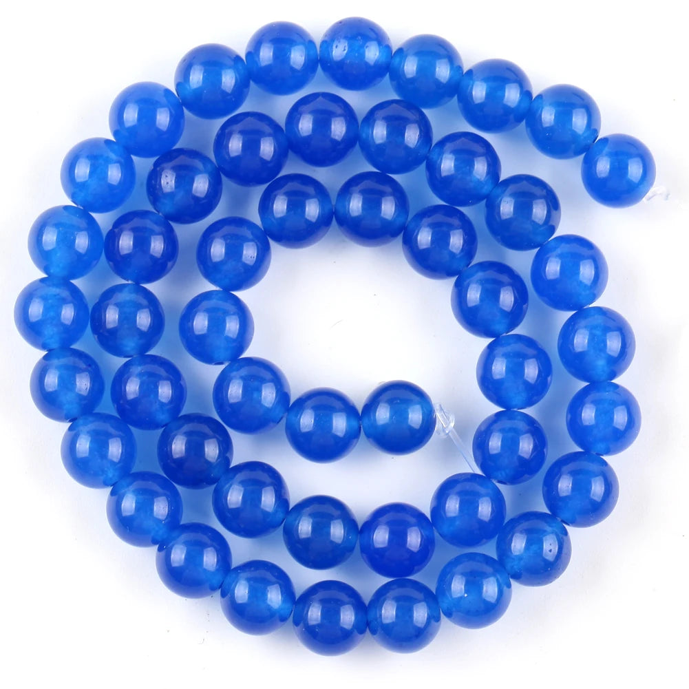 A string of round, polished blue beads made from natural sea sediment jasper and turquoise for jewelry making