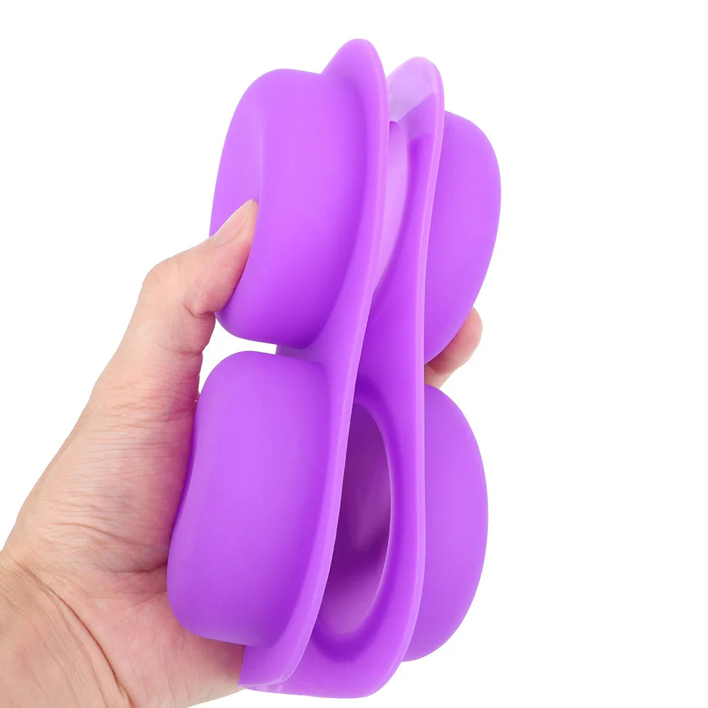 A hand holds a purple reusable silicone soap mold with four cavities for DIY crafts.