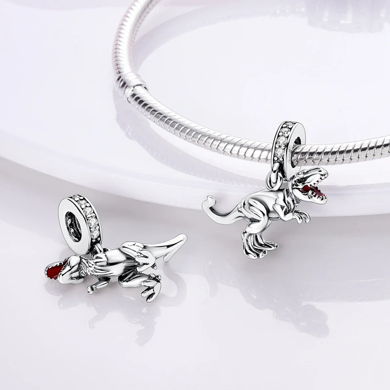 Sterling silver charm beads shaped like a rabbit and a fox attached to a bracelet chain