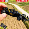 A black 1:64 scale alloy RC drift car is held by a hand, set against a blurred outdoor background.