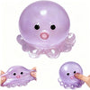 A translucent purple octopus squishy stress ball with small eyes and a pink mouth is shown in two views.