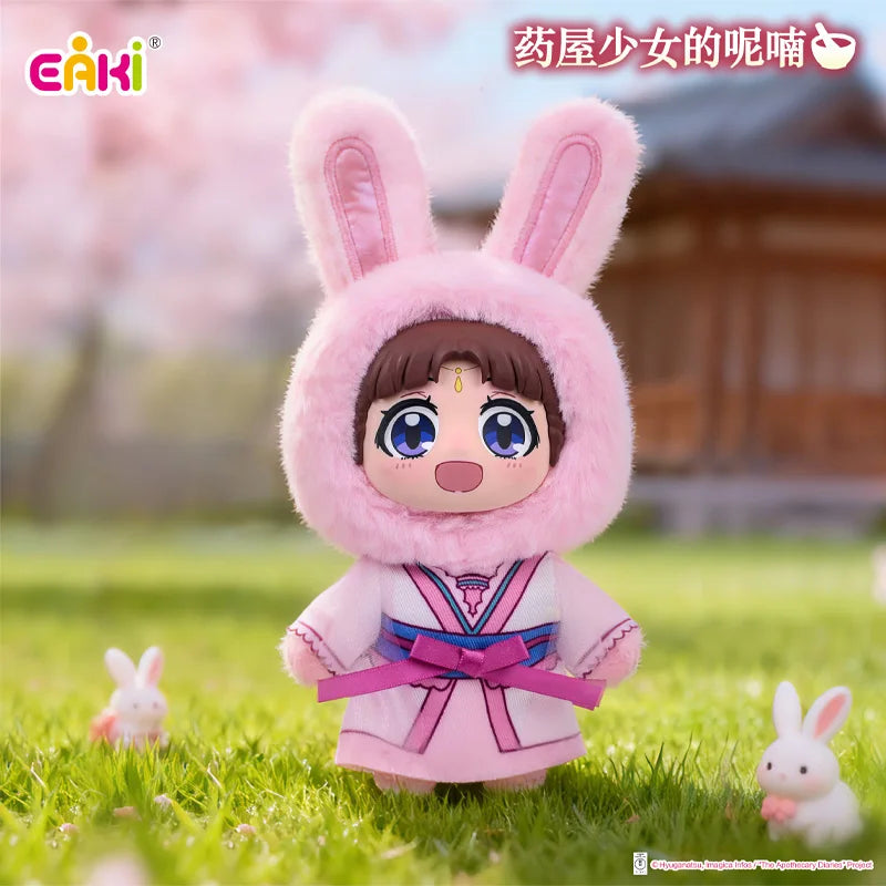 A plush blind box of a rabbit-eared girl in pink attire with a pink hood standing in a grassy outdoor setting.