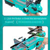 A hand holds a teal airplane launcher toy with foam planes, demonstrating how to lower the second plane.