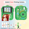 A green instant color printing camera with a dinosaur-themed design, showing examples of printed photos and accessories.