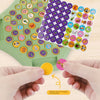 A hand is placing small animal stickers onto a green board for an Animal Flip Chess memory matching game.