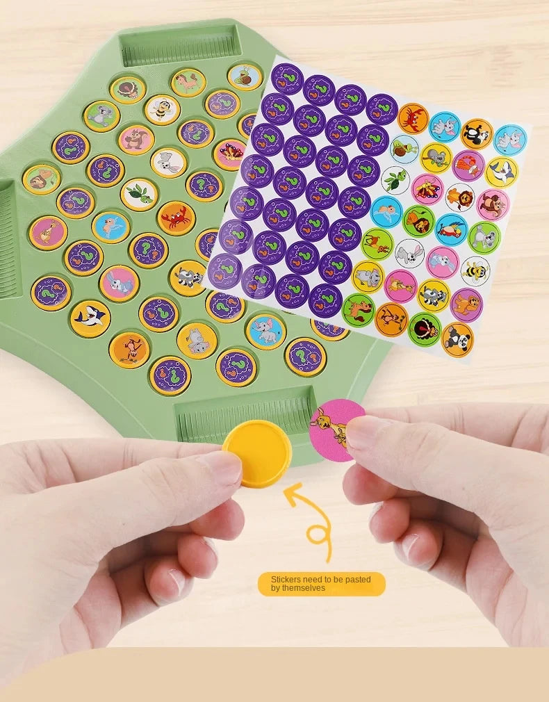 A hand is placing small animal stickers onto a green board for an Animal Flip Chess memory matching game.