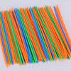 A collection of thin, colorful paint sticks in various shades of orange, green, and blue arranged diagonally.
