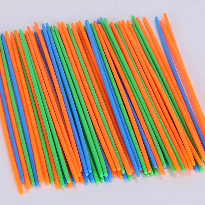 A collection of thin, colorful paint sticks in various shades of orange, green, and blue arranged diagonally.