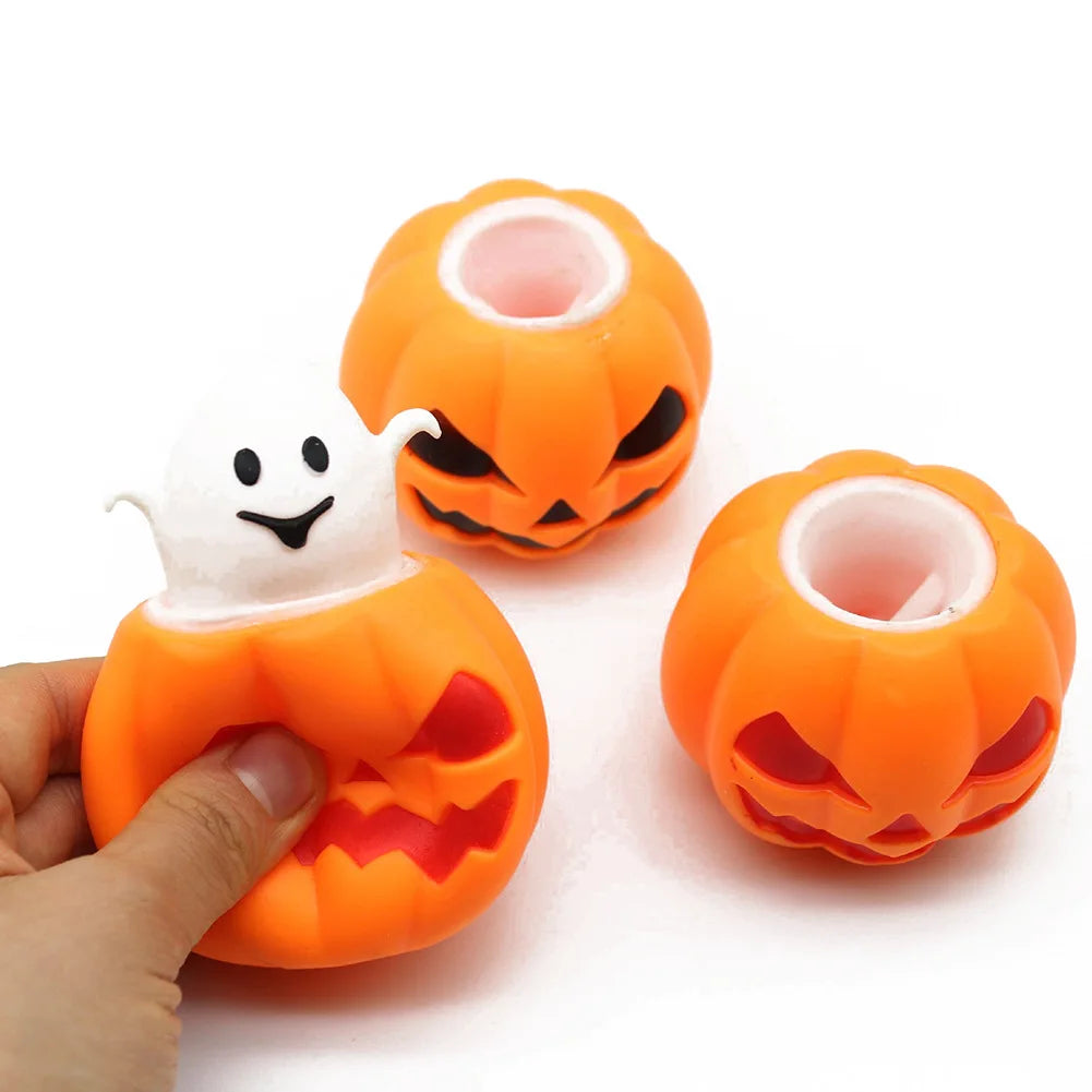 An orange squishy fidget toy shaped like a Halloween pumpkin with a ghost face detail.