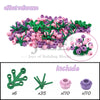 A collection of pink and green building blocks, including various shaped pieces like leaves and flowers.