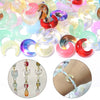Assortment of colorful moon-shaped glass beads for DIY jewelry making, shown alongside finished earrings and a bracelet.
