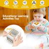 A toddler is playing with a white sensory cube toy while learning curiosity, hand-on ability, coordination, and attention ski