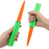 A hand holds an orange and green 3D printed butterfly knife fidget toy with a pointed tip.