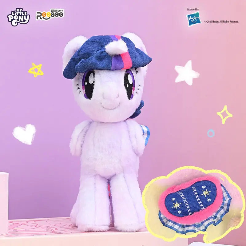 A fluffy white My Little Pony plush pendant with a blue and purple hat and detachable saddle