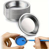 A hand holds a paintbrush dipping into a blue paint palette from a stainless steel artist set.