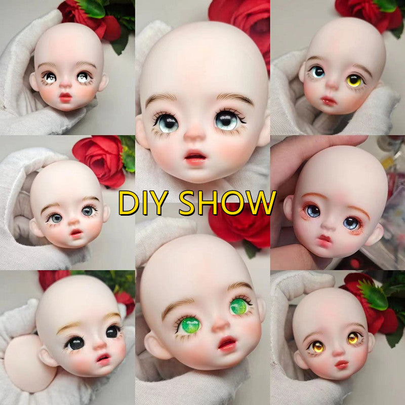 A close-up display of several realistic, baby-faced BJD dolls with large blue and green eyes.